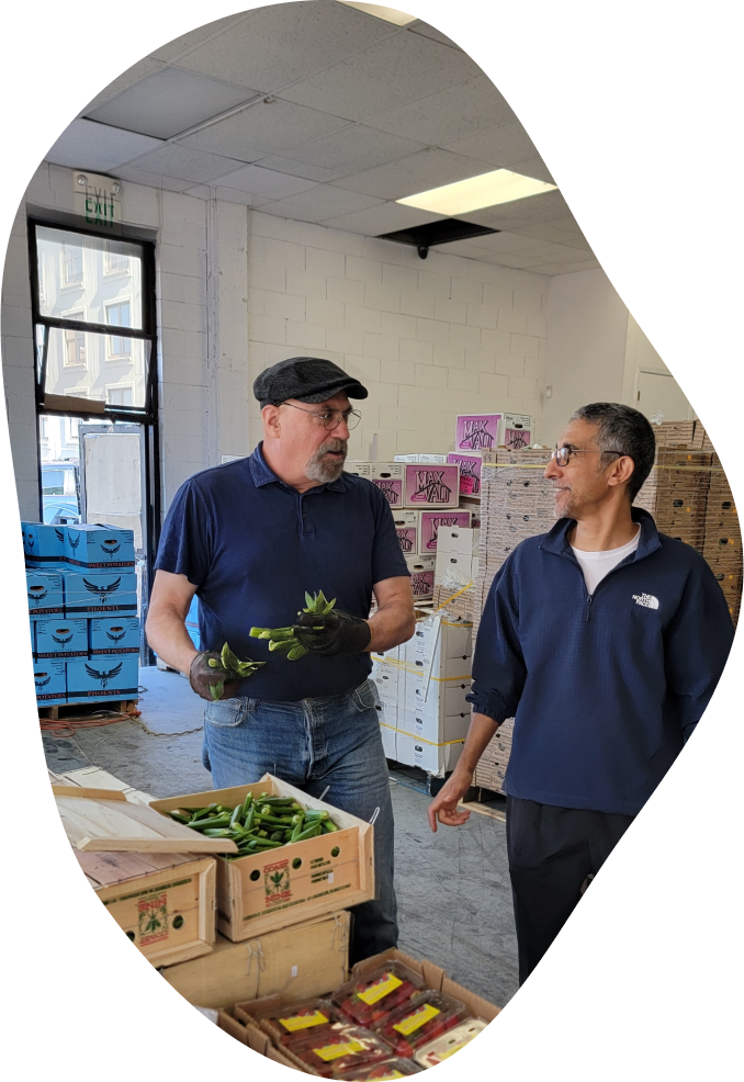 Dan Avakian holding fresh produce in warehouse